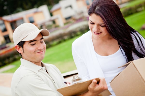 Casual man delivering a package and asking for signature